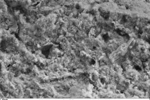  14 SEM micrograph of the fracture face of a thin-bed mortar sample containing 10 vol.% silica, in 1000-fold magnification 