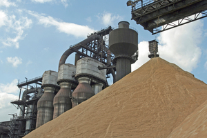  Freshly produced granulated blast furnace slag in front of a blast furnace 