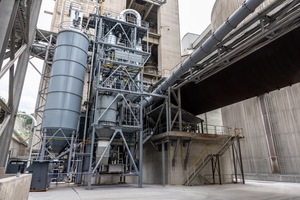  1 Front view of the plant. On the left is the silo with the raw material. In the middle are the cyclones and the combustion chamber. On the right, the rotary kiln and the pipe for the clinker cooler exhaust air 