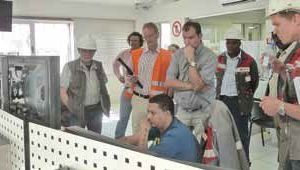  2 Ohorongo employees looking on as the VDZ audit is taking place in the control room at the Sargberg plant 