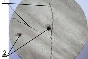  14	Macrocracks of various sizes on the surface of the lime sample obtained from the Precambrian limestone cylindrical sample (1-contraction macrocracks, 2-holes for the thermocouple) 