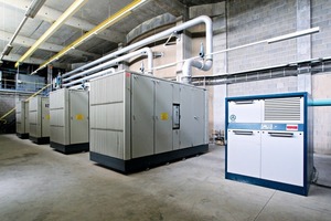  3 Four large screw compressors and four rotary blowers are working in a hall as a central air system 