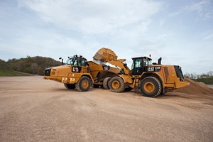 A Cat 972M XE wheel loader off-loading on a 730C articulated truck