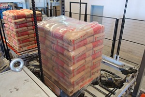 Roller conveyors transfer the palletised bags to the Beumer stretch hood A