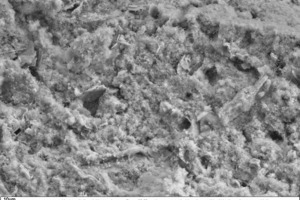 24 SEM image of the fracture face of a typical thin-bed mortar specimen containing 10 vol.% fumed silica in 1000-x (left) and 5000-x magnification (right) after a setting time of 28 days in air