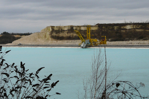 8 (a) The submerged dredging operation at Obourg and (b) exposed bucket chain excavator on land for maintenance purposes