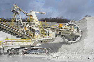9 The mining operation at Lägerdorf with (a) a bucket wheel excavator up close and (b) from a distance, showing the limitation of the mining method not to separate the inclined dark flint layers