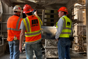 2 Martin service technicians examine a silo to determine the best solution