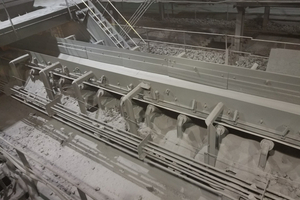 The return side of the belt at this rock quarry is completely encapsulated by dust and spillage